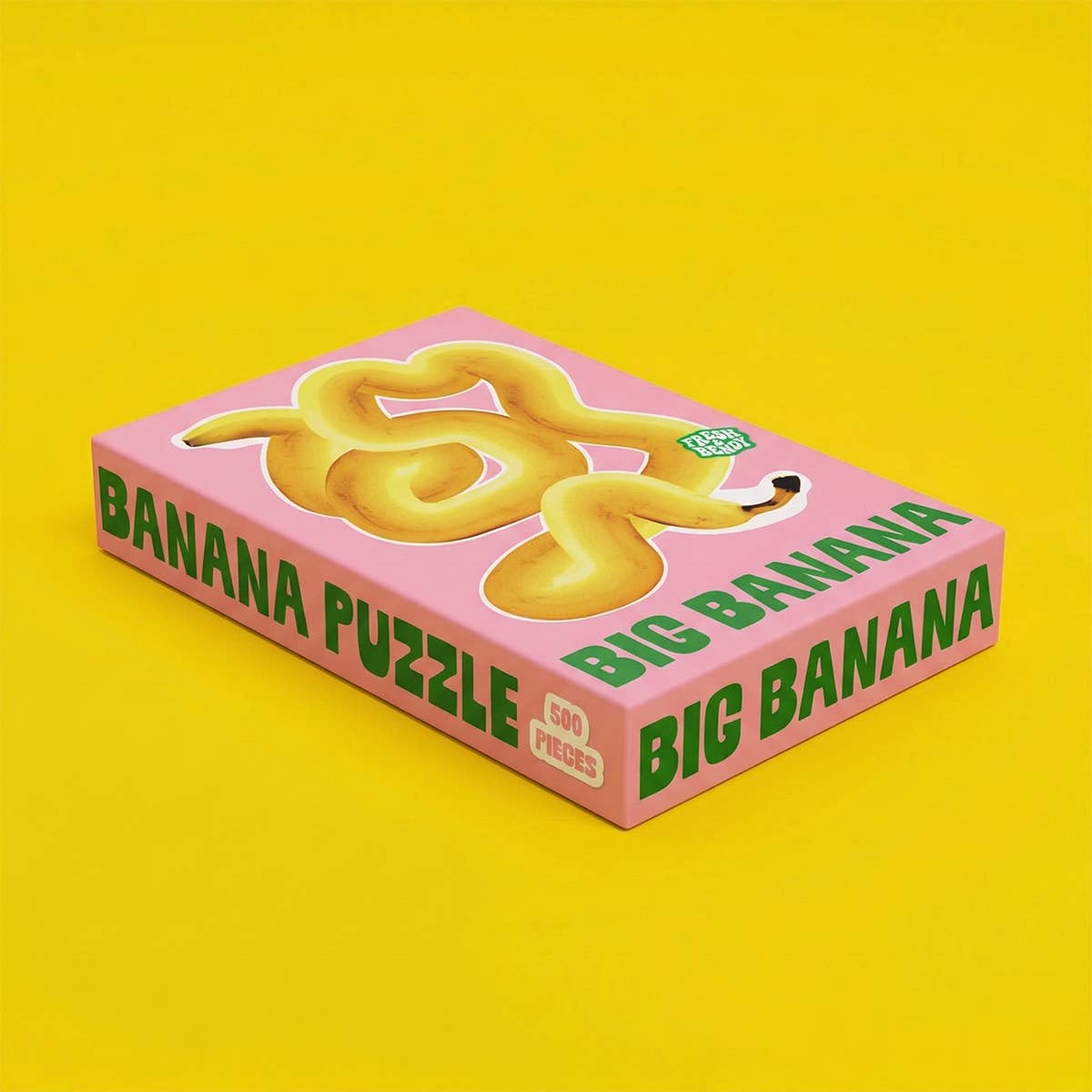 Big Banana Puzzle 500 Teile rosa Schachteln gelber Hintergrund