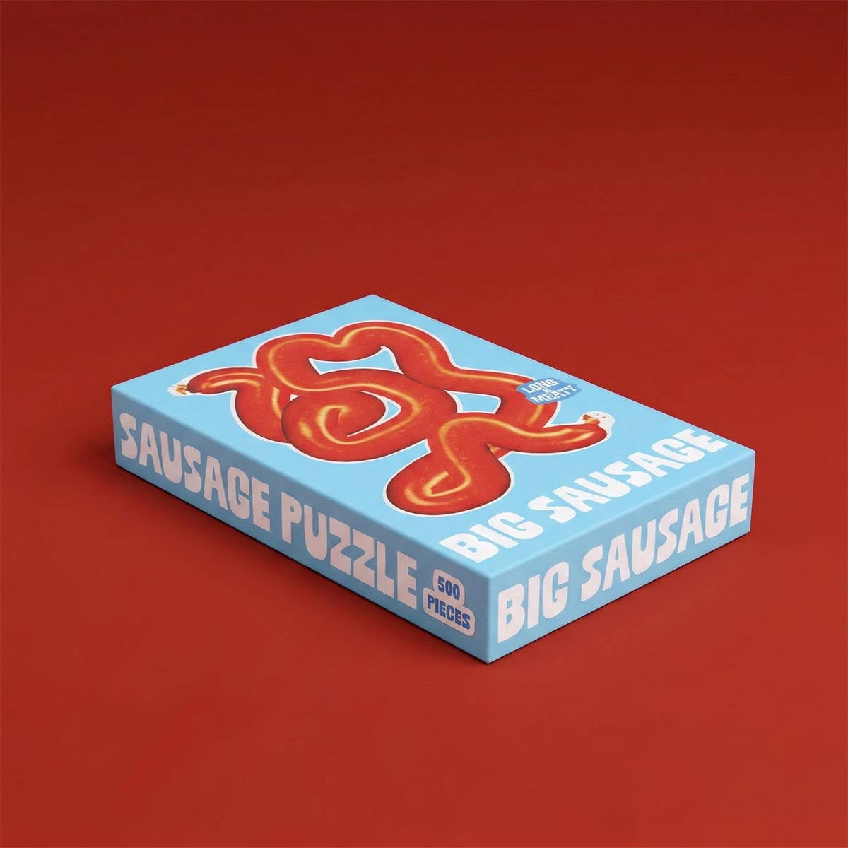 Sausage Puzzle 500 Teile Schachtel mit roter Wurst auf blauem Hintergrund