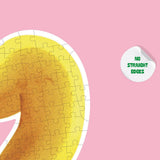 Gelbes Bananen-Puzzle mit weißen Rändern auf rosa Hintergrund, 500 Teile